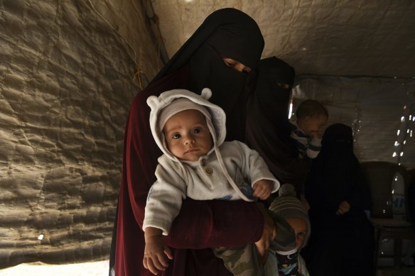 Kirsty Rosse-Emile, 25, holding her two-month-old son Yahya, the youngest Australian baby in al-Hawl camp in Syria in October. 