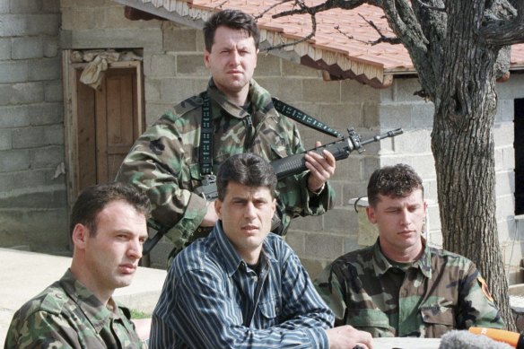 Hashim Thaci, then head of the Kosovo Albanian negotiation team and of the Kosovo Liberation Army political directorate, centre seated, addresses a press conference in a secret location in central Kosovo in 1999.
