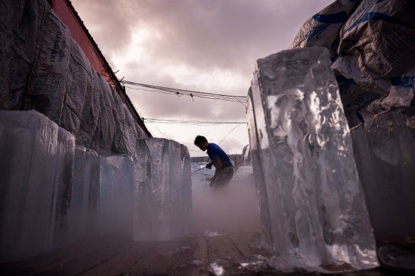 A man unloads blocks of ice from a truck during a heatwave in Bangkok, Thailand, on Sunday.