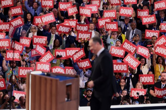 Delegates hold “Doug” signs while the US second gentleman speaks at the convention.