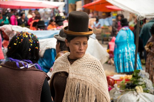 A woman in traditional dress shopping at a market in La Paz. There’s something deeply invigorating about Latin America.