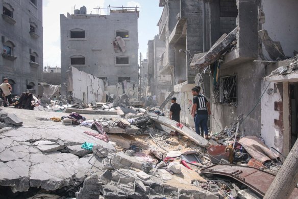 Palestinians inspect the rubble of a building after an Israeli airstrike in central Gaza last month.