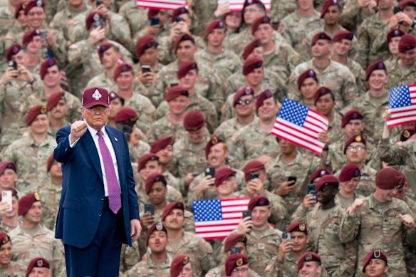 Trump gestures on stage after his speech at Fort Bragg on Tuesday.