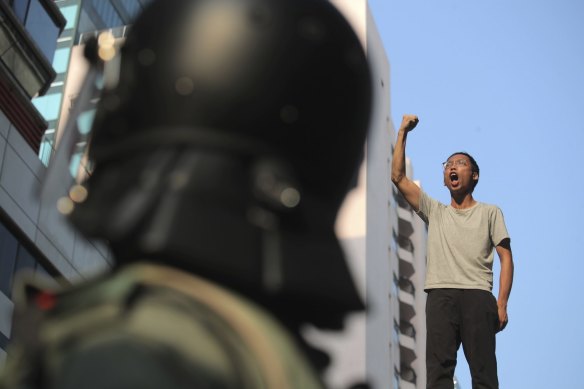 A man shouts slogans as he's stopped by police while trying to escape the Hong Kong Polytechnic University this week.