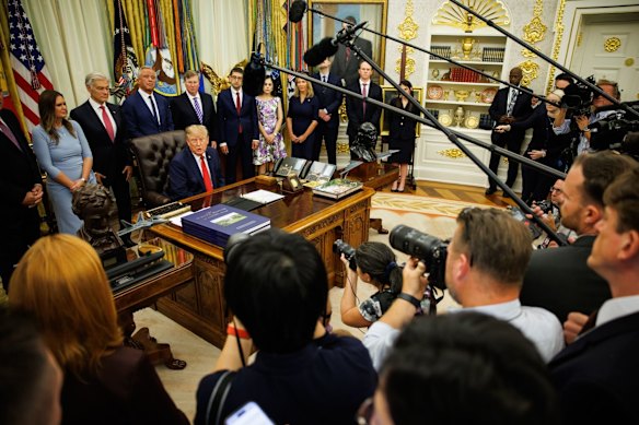 The White House press pool in the Oval Office on Friday.