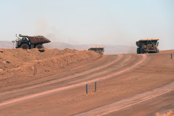 Autonomous haul trucks travel along a road at Rio Tinto’s Gudai-Darri iron ore mine.