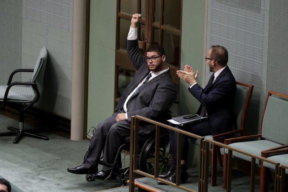 Senator Jordon Steele-John raises his fist in 2019 after the House of Representatives agreed to a disability royal commission.
