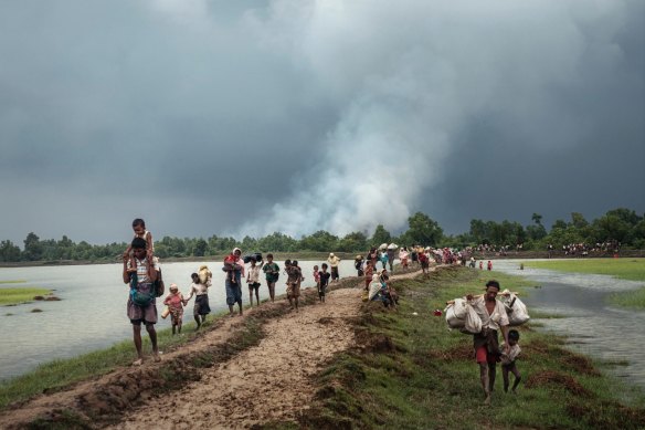 Rohingya refugees rest near the Naf River, which separates Myanmar and Bangladesh, after crossing the border in 2017.