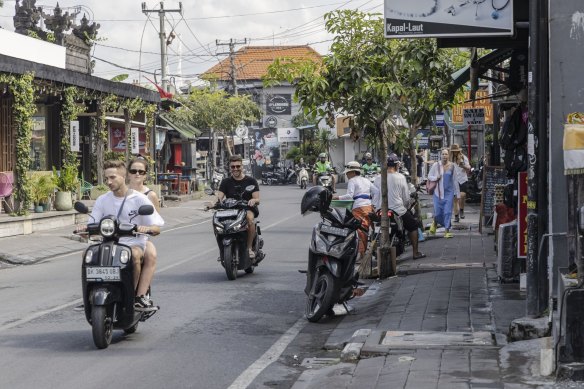 Tourists ride scooters in Canggu during the peak season of December.
