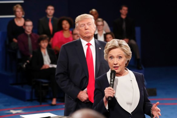 Donald Trump stands behind Hillary Clinton during a 2016 debate.