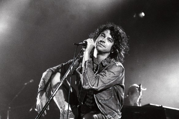 Michael Hutchence with his ankle in plaster performs with INXS at the Hordern Pavilion on 27 October, 1994.