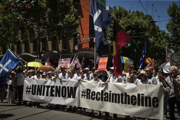 The crowd marches up Swanston Street on Sunday.