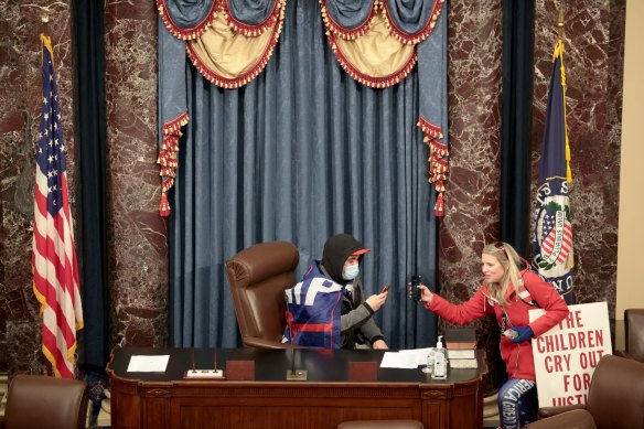  A protester sits in the Senate Chamber as others roamed the halls. 