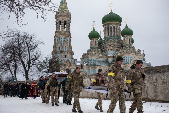 Ukrainian soldiers are carrying the body of Denys Hrynchuk from Hrynchuk family’s house to the church in Bila Krynytsia.