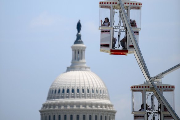 Attendees on the Ferris wheel during the State Fair of America on the National Mall on July 4.