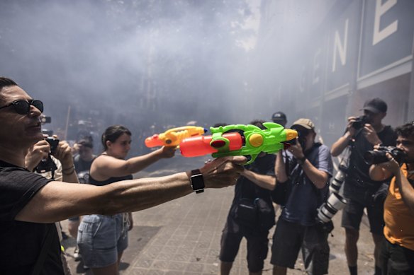 Demonstrators shoot water pistols as part of a protest by Barcelona’s Neighbourhoods Assembly for Tourist Degrowth in June.