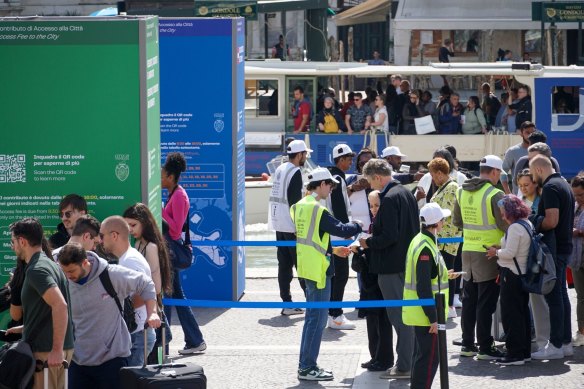 Tourists day-entry tickets to Venice are checked in May this year.