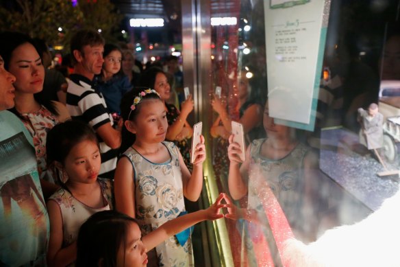 Families outside Myer's Christmas windows in 2015.