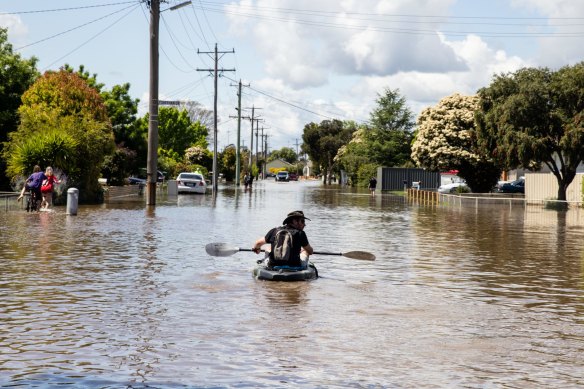 A local paddles along a flooded street in Shepparton on Sunday.