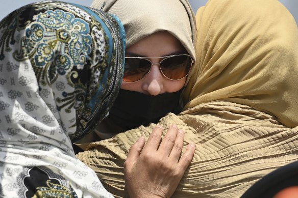 Family members comfort each other during the funeral service for Talat Afzaal, 74, her son Salman Afzaal, 46, his wife Madiha Salman, 44, and their 15-year-old daughter Yumna Salman.