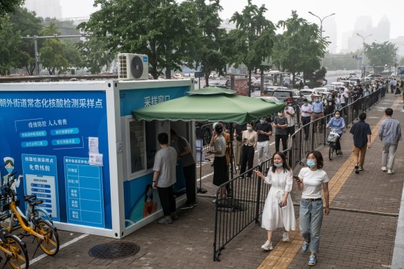 Residents queue at a COVID-19 testing booth in Beijing, China, on Tuesday. 