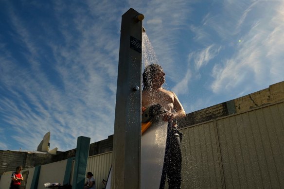 JR rinses off near the ocean baths at Newcastle during the statewide COVID-19 lockdown. 
