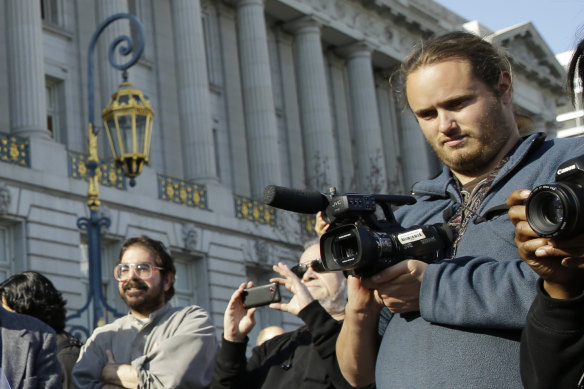 David DePape, right, records a nude wedding outside San Francisco’s City Hall in 2013. DePape is accused of breaking into House Speaker Nancy Pelosi’s home and beating her husband with a hammer.