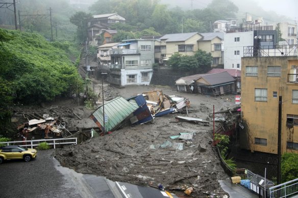 A powerful mudslide carrying a deluge of black water and debris crashed into rows of houses in Atami, south-west of Tokyo on Saturday.