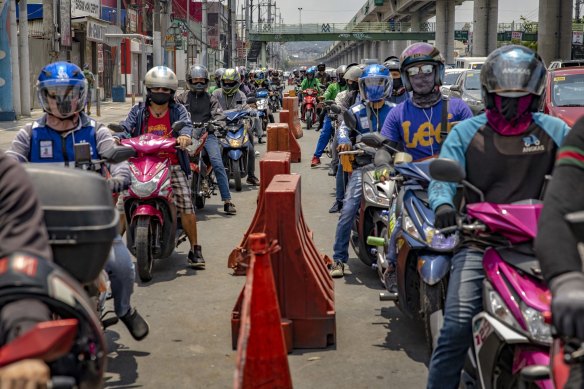 Motorists queue at a quarantine checkpoint in Manila, Philippines.