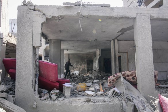 A Palestinian man in the remains of a destroyed building following an Israeli airstrike in a residential neighbourhood at the Nuseirat refugee camp in central Gaza on Saturday.