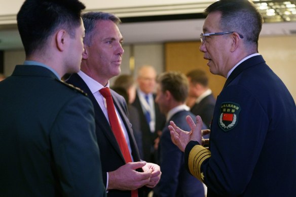 Defence Minister Richard Marles (centre) with China’s  Defence Minister Dong Jun (right) at the Shangri-La Dialogue.