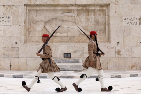 Presidential guards perform the Changing of the Guards in front of the Greek parliament building in Syntagma square in Athens, Greece, on Monday.