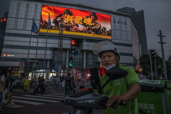 A screen displaying a People’s Liberation Army ad in Beijing. 