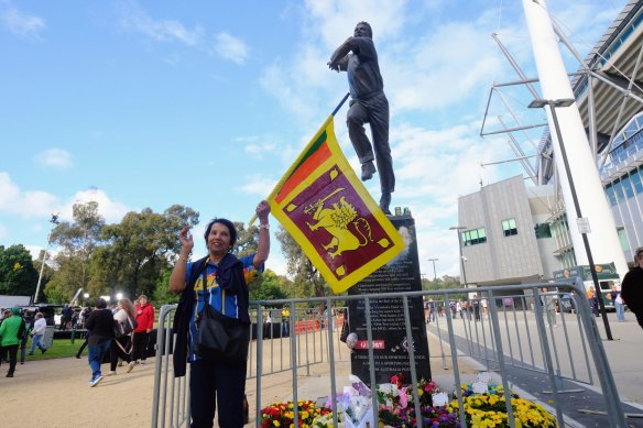 People arrive at MCG paying respects at Shane Warne's statue before the gates open for his  memorial service.
