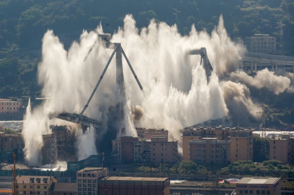 A cloud of dust rises as the remaining spans of the Morandi bridge are demolished in a planned explosion in June 2019. 