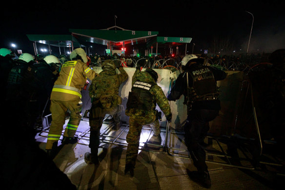 Members of Poland’s Territorial Defence Force secure the fence at the closed Kuznica border crossing where thousands of migrants has been relocated by Belarusian soldiers in 2021. 