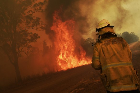 Firefighters tackle a blaze in NSW on a Wednesday when a total fire ban was in force.