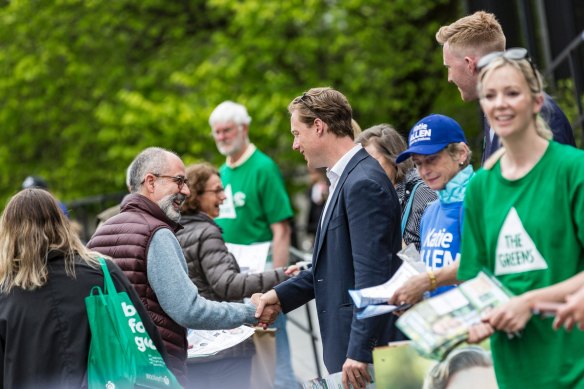 Greens MP Sam Hibbins (centre) says people are crying out for supermarket price controls. 