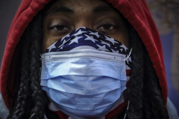 A subway rider wears a mask and a bandana for protection against COVID-19 in New York. The coronavirus has been previously been found to be hitting black Americans particularly hard. A new study points to the same situation in the UK. 