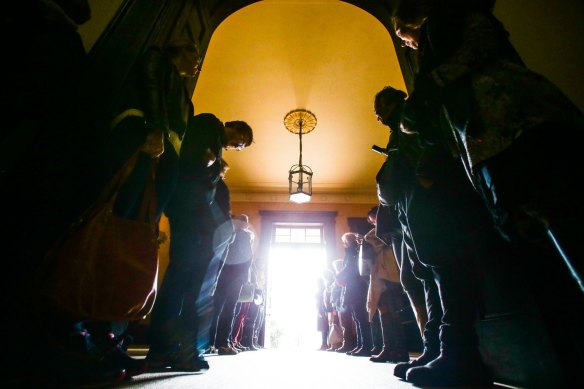 Crowds gather at Elizabeth Bay House to watch the sun stream through the front door during the winter solstice.