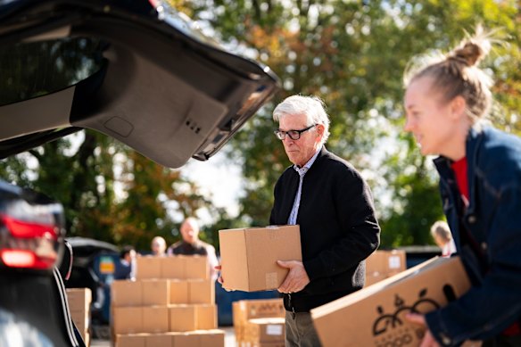Democrats congressman Don Beyer (left) loads a food box into a car at a food bank in Virginia last month.