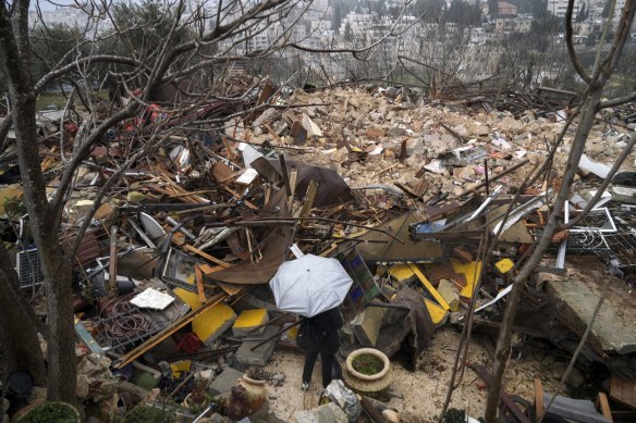 A woman looks at the ruins of a Palestinian house demolished by the Jerusalem municipality in the occupied east Jerusalem neighbourhood of Sheikh Jarrah.