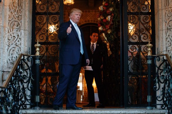 Then president-elect Donald Trump gives a thumbs up after speaking to reporters at Mar-a-Lago in 2016.
