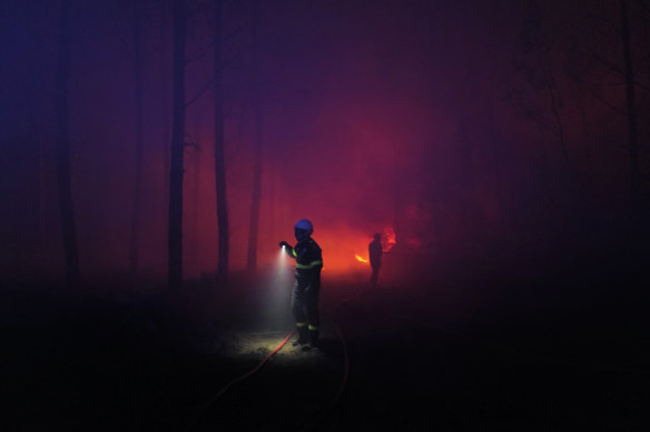 Firefighters at a wildfire  near Landiras, south-western France.