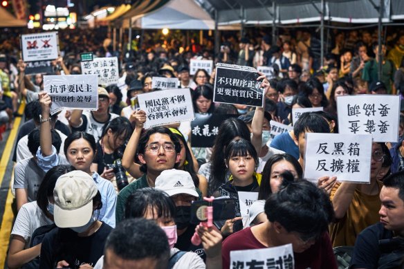 Protesters rally against proposed changes to executive powers outside Taiwan’s Legislative Yuan on Tuesday night.