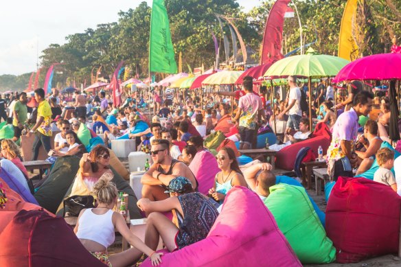 Tourists enjoy a drink in a beach bar along Seminyak beach.