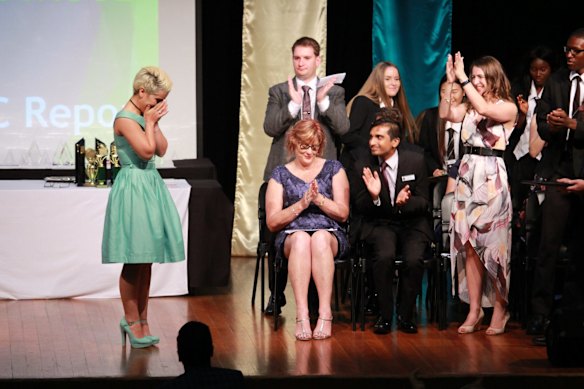 An emotional moment on stage as Mojgan Shamsalipoor graduates at the Yeronga State High School awards night.