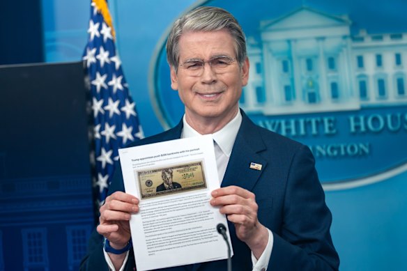 Treasury Secretary Scott Bessent holds up an image of the proposed $250 note.
