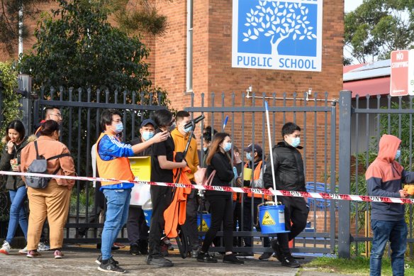 Cleaners leave South Coogee Public School after deep cleaning due to a COVID-19 outbreak at the school. 