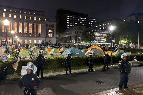New York City police officers surround a pro-Palestinian student encampment at Columbia University.